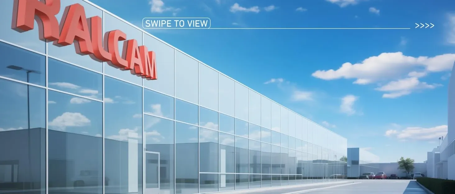 Exterior view of a modern glass-fronted RACCAM building with large red signage against a blue sky.
